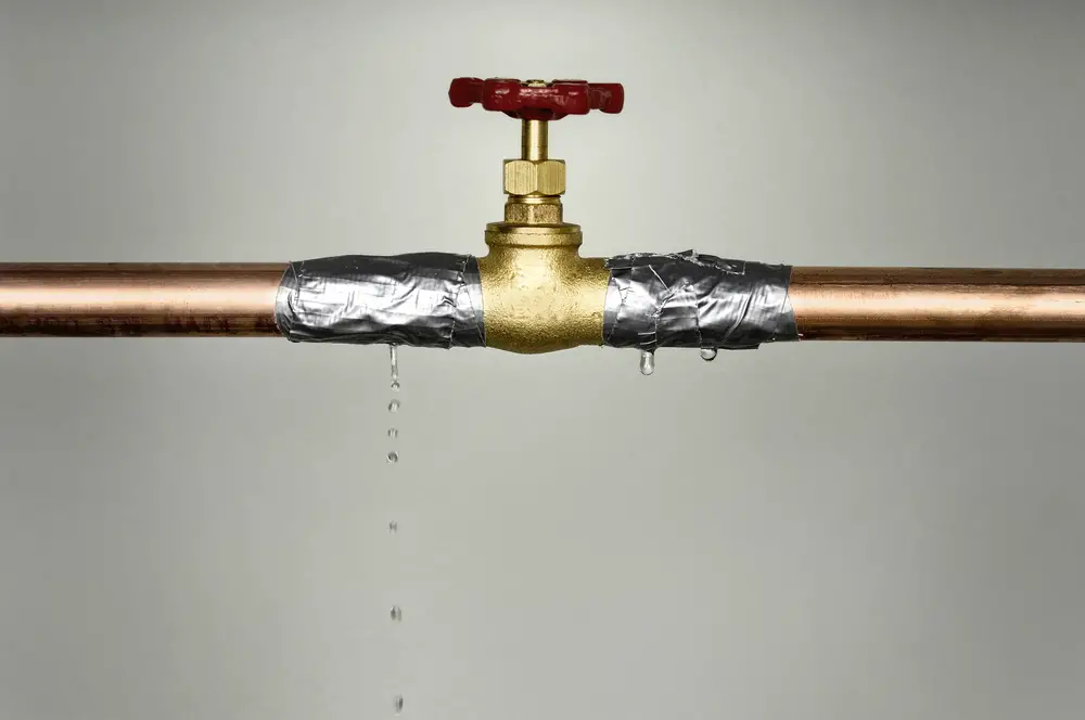Closeup shot of the leaking water pipe