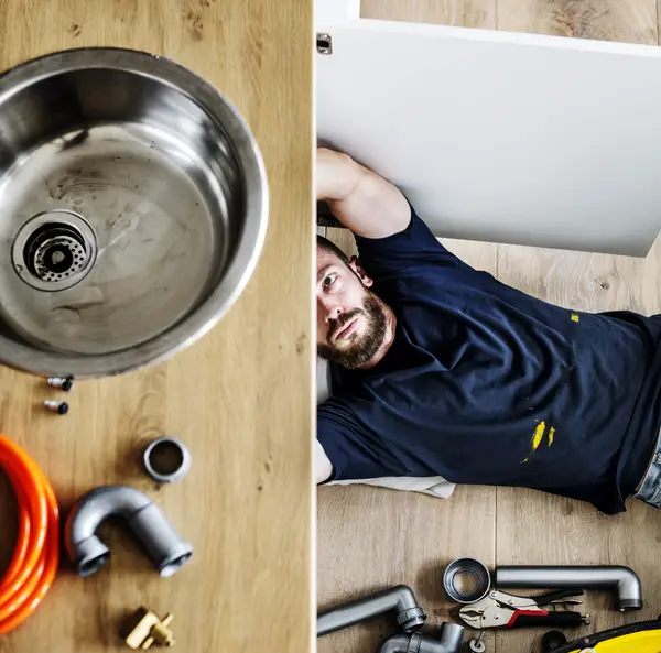 plumber fixing clogged sink